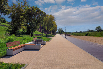 Malbork, Poland - a promenade along the Nogat River near the Teutonic Castle, on the right the rebuilt municipal public library in the former Latin school