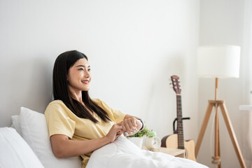 Asian young beautiful woman looking on smartwatch checking sleep rate. 