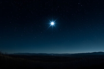 A star is shining brightly in the night sky. The sky is dark and the stars are scattered all over