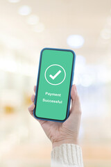 Hand holding smart phone with payment successful on screen, online banking, shopping online, cashless transaction