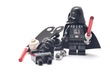 Obraz premium Lego minifigure of Darth Vader of Star Wars with red lightning sword isolated on white. Editorial illustrative image of popular plastic constructor and 25 Anniversary