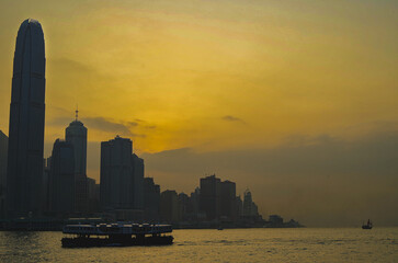 Obraz premium Panoramic skyline silhouette view of Hongkong Hong Kong Victoria Harbor and port infrastructure bay scenic landscape seascape scenery during twilight blue hour in China