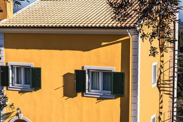 Vintage traditional yellow stone house in a small town in Corfu Island Greece