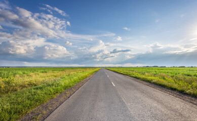 Fototapeta premium A long road with a clear blue sky above it