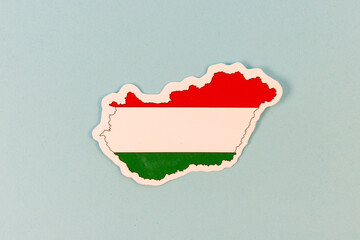 Hungary Map Shaped Sticker with National Flag Design on Light Blue Background with Copy Space.