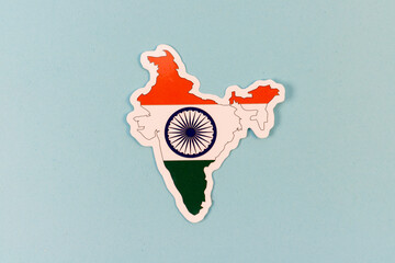 India Map with National Flag Colors and Ashoka Chakra on Light Blue Background with Copy Space.