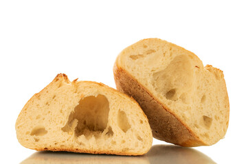 One wheat loaf cut in half, macro, isolated on white background.