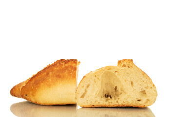 One wheat loaf cut in half, macro, isolated on white background.