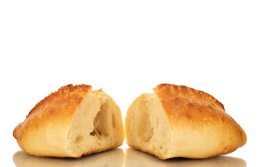 One wheat loaf cut in half, macro, isolated on white background.