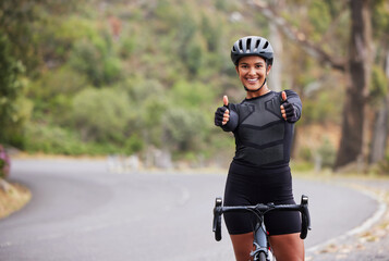 Sport portrait, woman and bike with thumbs up in road for workout success, adventure and physical...