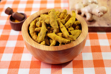 Curcuma roots in wooden bowl