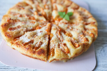 Apricot pie on a plate, close-up, selective focus.