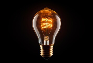 Glowing Vintage Light Bulb with Spiral Filament on Black Background