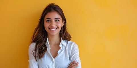 Headshot of a professional Israeli businesswoman in a suit, posing confidently with arms crossed and a smile, with blank background.