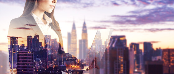 Headless young businesswoman with laptop standing on wide city background with mock up place....