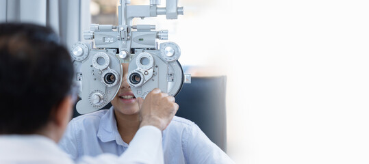 Boy doing eye test checking examination with optometrist in optics store, Indian kid boy choosing...