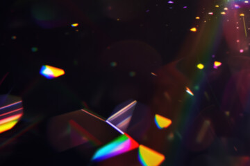 Fototapeta premium Iridescent prism light effect on black background, rainbow of colors on the black background. Glowing colorful lights and a bokeh lens flare with space, abstract refraction of sunlight prism effect