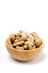 Wooden bowl filled with boiled peanuts (Arachis hypogaea), perfect as a snack, photographed against a white background.