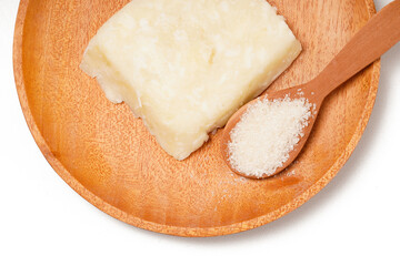 Getuk: a traditional Indonesian snack made from boiled cassava mixed with sugar and grated coconut, then mashed and shaped into flat squares. Photographed on a white background.
