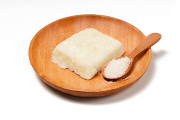 Getuk: a traditional Indonesian snack made from boiled cassava mixed with sugar and grated coconut, then mashed and shaped into flat squares. Photographed on a white background.