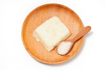 Getuk: a traditional Indonesian snack made from boiled cassava mixed with sugar and grated coconut, then mashed and shaped into flat squares. Photographed on a white background.
