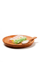 Sentiling, or Lapis Singkong, is a sweet Indonesian snack made from cassava, colored red, yellow, and green. Served with grated coconut or sugar. Photographed on a white background.