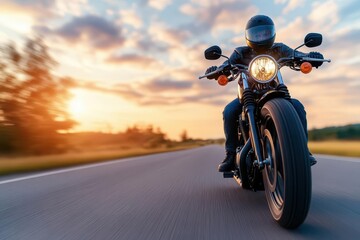 A motorcyclist rides along an open road at sunset, showcasing speed and freedom in a vibrant landscape.
