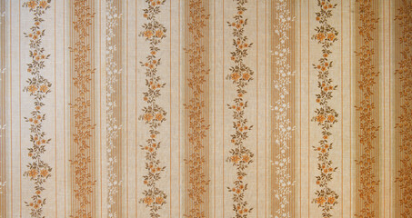 Old wallpaper on the wall. Old wallpaper for texture or background.