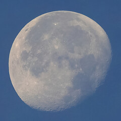 Full moon over blue sky