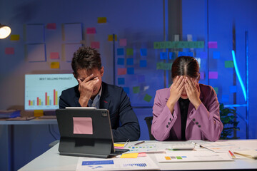 Tired and stressed Asian businesswoman, accountant and marketing officer are having a headache from overwork with piles of deliverables in the office. working overtime Office syndrome concept.