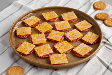 Gourmet Cheese Meat and Crackers on a Plate, side view.