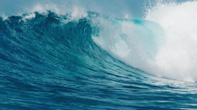 Surfer paddles in the ocean with big ocean wave breaking on the background in the Maldives