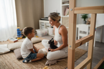 Fototapeta premium Mother and Little Son Playing Together with Stuffed Toys on the Floor at Home