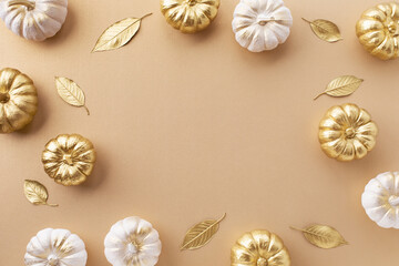 Stylized white and gold decorative pumpkins and golden leaves on a pale beige background for autumn and Thanksgiving cards.
