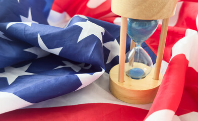 USA red white and blue flag with hour glass showing time is running out for democracy freedom and...