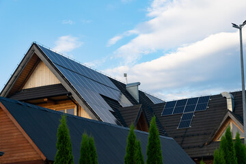 photovoltaic panels on a black roof at sunset