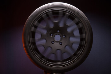 sports matte black car rims illuminated by blue light, long exposure photography for motion blur...