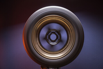 sports matte black with bronze car rims illuminated by blue light, long exposure photography for...