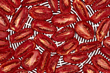 Delicious sun dried tomatoes with seasonings flavoring are placed on pallet for drying