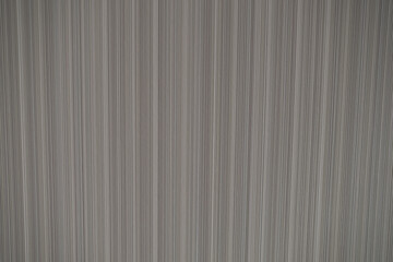 Fototapeta premium Close-up of vertical striped fabric texture in shades of grey, creating a linear pattern