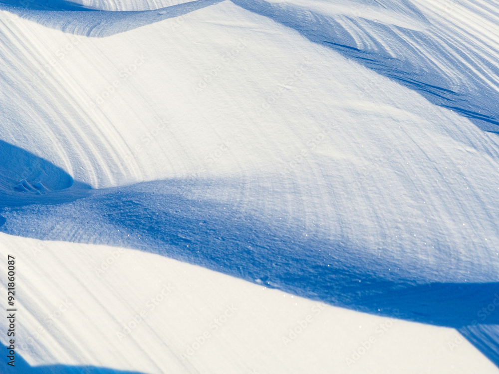 Wall mural snow texture. wind sculpted patterns on snow surface. wind in the tundra and in the mountains on the
