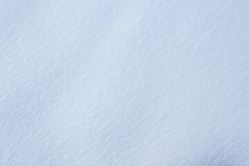 Fototapeta premium Natural snow texture. Smooth surface of clean fresh snow. Snowy ground. Winter background with snow patterns. Perfect for Christmas and New Year design. Closeup top view.