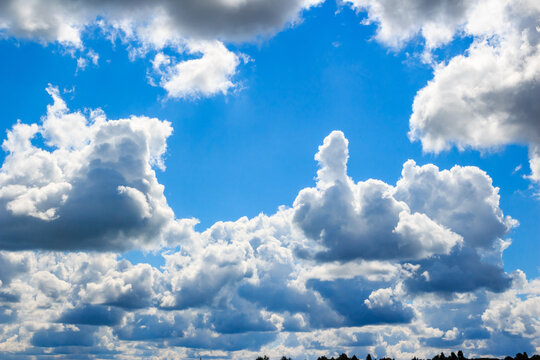 Cloud of unusual shape in the form of a phallus or fuck you on the background of blue sky. Funny sign in the sky without photomontage