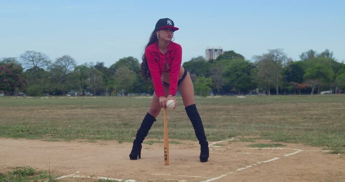 A girl wearing a baseball bikini outfit in a lush field on the vibrant island of Trinidad.
