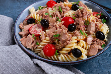fusilli pasta salad with canned tuna, cherry tomatoes and olives, parmesan, microgreens, homemade, no people,