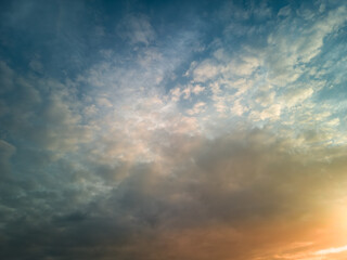 The rays of the sun breaking through the dramatic clouds in the evening or in the morning in the sunset or sunrise sky.