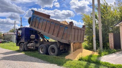 Obraz premium A truck brought sand for the construction site. Bulk cargo delivery