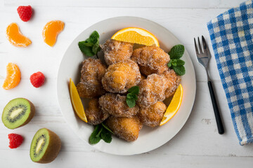 Delicious traditional Spanish fritters. Table decorated with Christmas decorations.