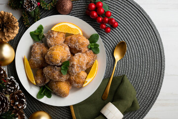 Delicious traditional Spanish fritters. Table decorated with Christmas decorations.