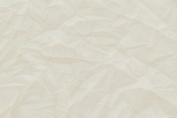 Crumpled textile, white surface for background. Cream color battered fabric, texture with copy...